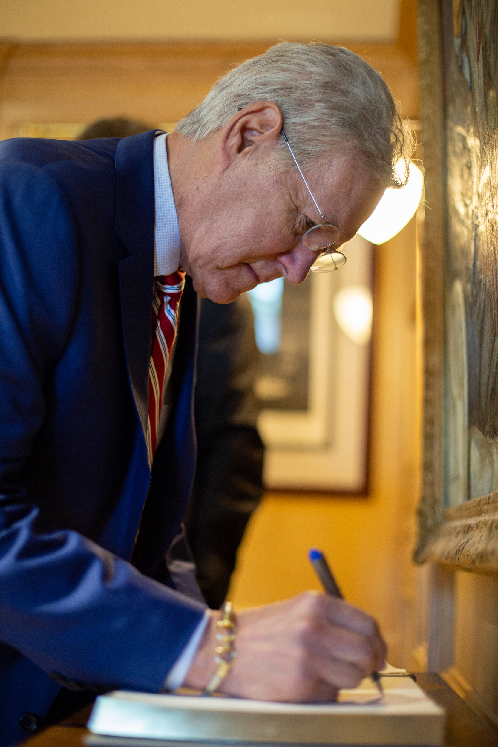 Alex Trebek signs a guestbook