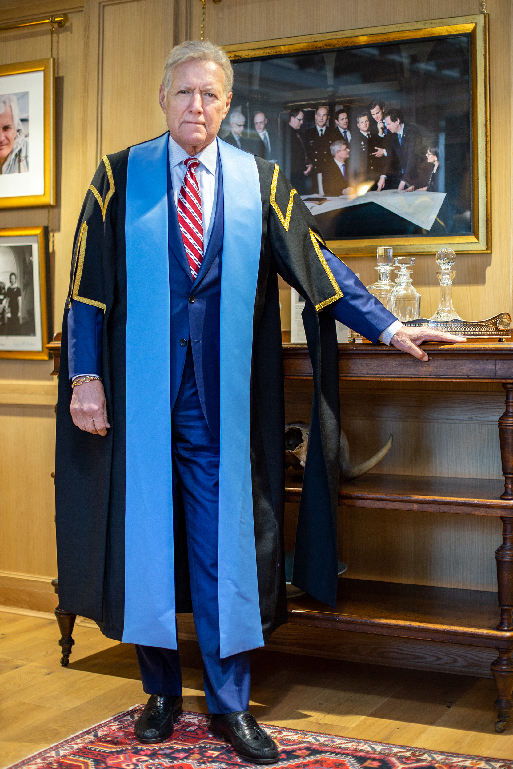Alex Trebek poses in robes