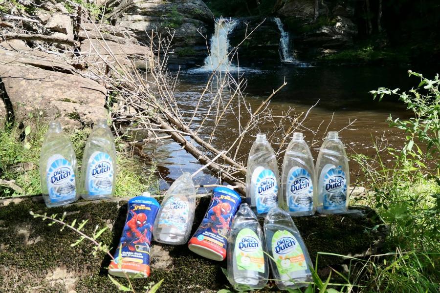 Photo: Adam Malcolm Empty dish soap bottles arrayed in front of a pond in Nova Scotia